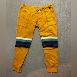 Aviator Nation Mustard sweatpants with blue stripes on knees
